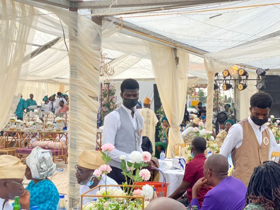 MANSA staff serving drinks among floral arrangements