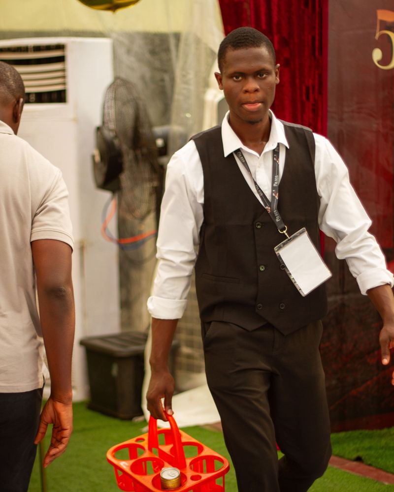 MANSA staff in uniform carrying a drinks caddy